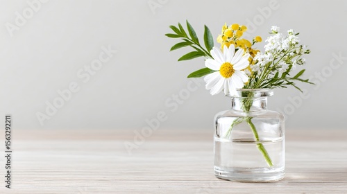 Minimalist wildflower arrangement in a vintage glass bottle on neutral background, soft pastel tones, perfect for wellness or editorial, with space for text.