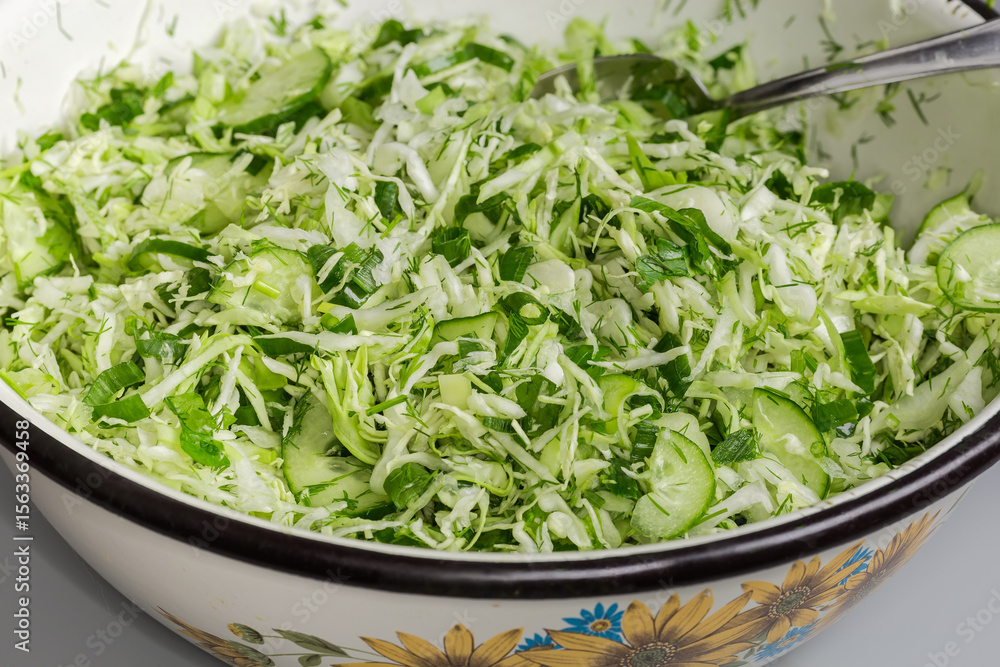 Green vegetable salad in big kitchen bowl, fragment close-up Green vegetable salad in big kitchen bowl, fragment close-up