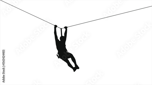 A silhouetted man hangs from a zipline cable against a light blue sky, enjoying an adventurous outdoor activity