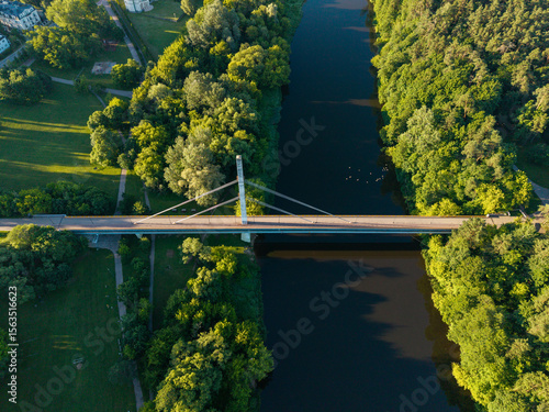 Top-down drone view of Vingio pedestrian bridge in Vilnius. Straight alignment over the Neris River.