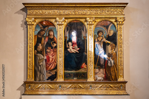 Collection of three renaissance religious paintings assembled in a large golden frame