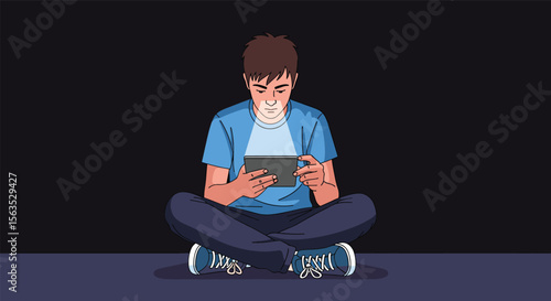 Young person focused on digital device while sitting cross-legged in low light environment