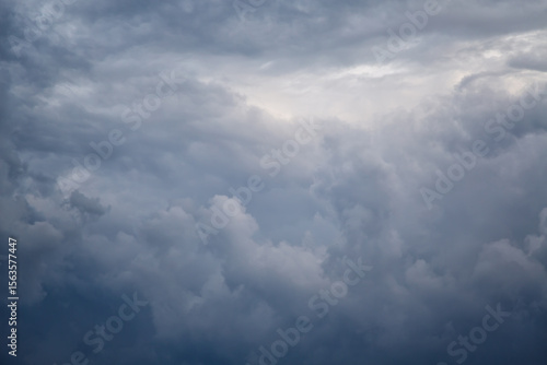 Blue cold clouds covered the sky in the skyline, textured clouds illuminated by cold blue light in the sky, a heavenly background with blue hazy clouds.