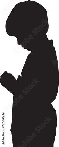 Boy wearing cap looking down silhouette focused