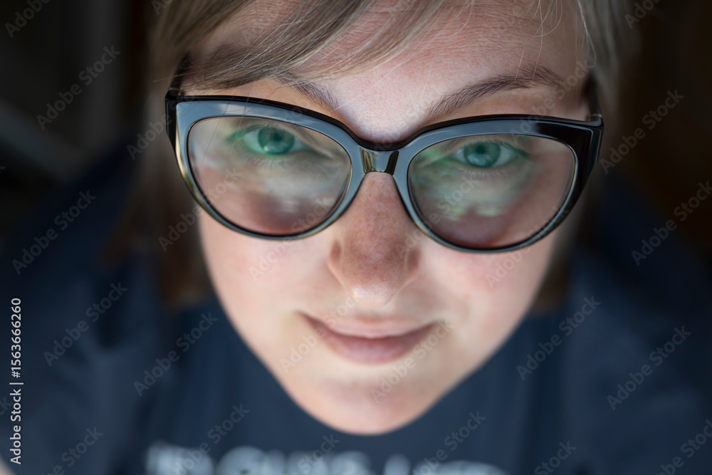 Fototapeta premium young blonde woman in glasses smiling looking at camera, street portrait. businesswoman, freelancer
