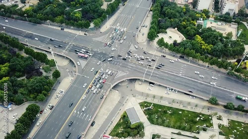 City traffic intersection in bustling urban area during daytime rush hour