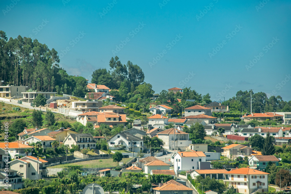 Fototapeta premium Cityscape of modern buildings near forest hills