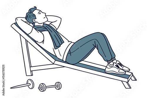 A man in athletic wear rests on an incline bench with his hands behind his head a towel around his neck and dumbbells nearby