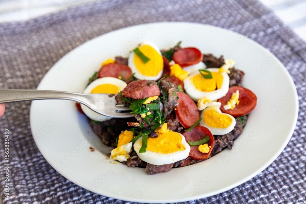 Traditional black bean tutu with kale, calabrese sausage, bacon and egg. A classic rustic dish from Minas Gerais Traditional black bean tutu with kale, calabrese sausage, bacon and egg. A classic rustic dish from Minas Gerais