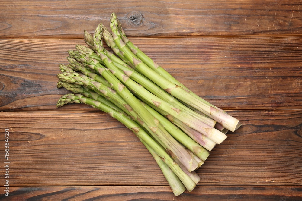 Fresh raw asparagus on wooden table, top view Fresh raw asparagus on wooden table, top view