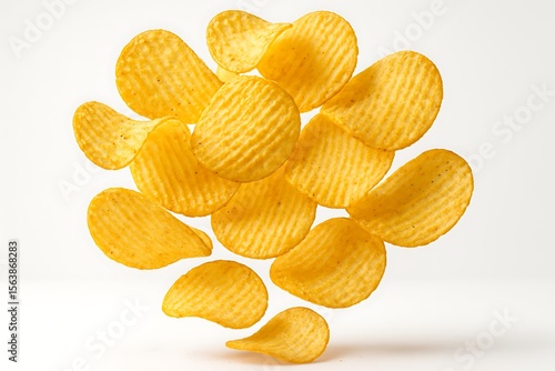 Crispy ruffled potato chips levitating in mid air against a white background