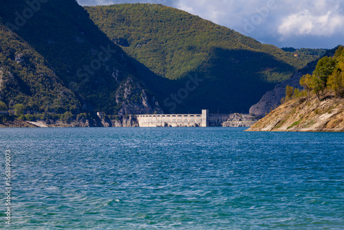 Majestic view of Lago del Salto Dam nestled between lush mountains and tranquil lake waters