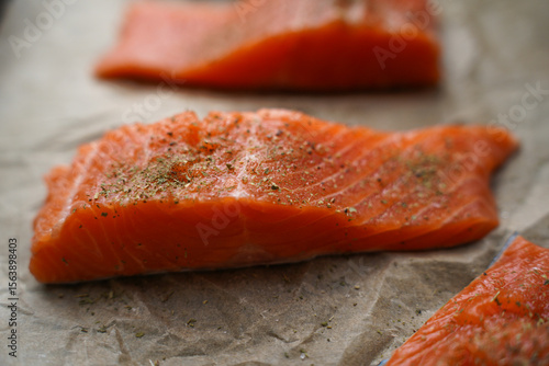 Fresh Raw Salmon Fillets with Herbs on Parchment Paper