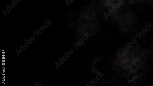 Dark background with wispy white smoke or fog swirling and drifting across the frame