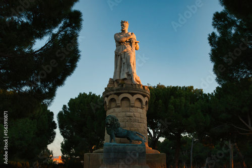 Statue of Alfonso I of Aragon with the lion, called “El Batallador” made in 1923. Located in “Parque Grande” at sunset in Zaragoza, Spain.