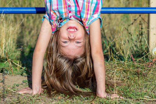 Konstfotografi Portrait of smiling caucasian child 7 8 years upside down