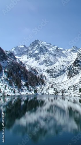 Wallpaper Mural Majestic snow-capped mountain range perfectly reflected in a calm alpine lake. Torontodigital.ca