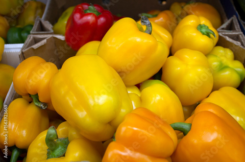 Close-up of sweet peppers lying in supermarket boxes.
