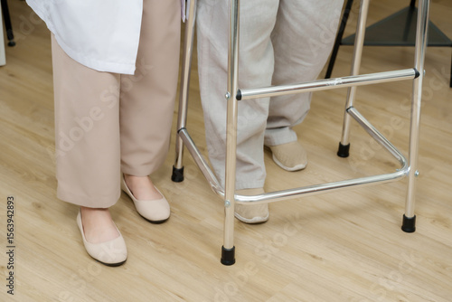 Obraz na plátně Feet of asian senior woman and orthopedic doctor walking side by side using walk
