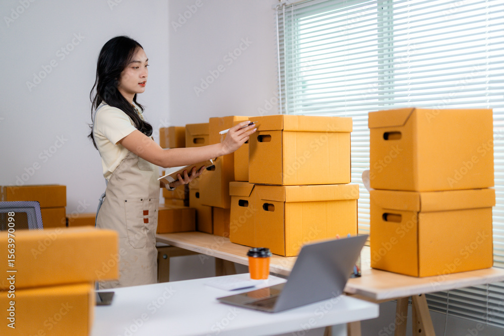Young Entrepreneur Organizing Inventory in Office Space Young Entrepreneur Organizing Inventory in Office Space