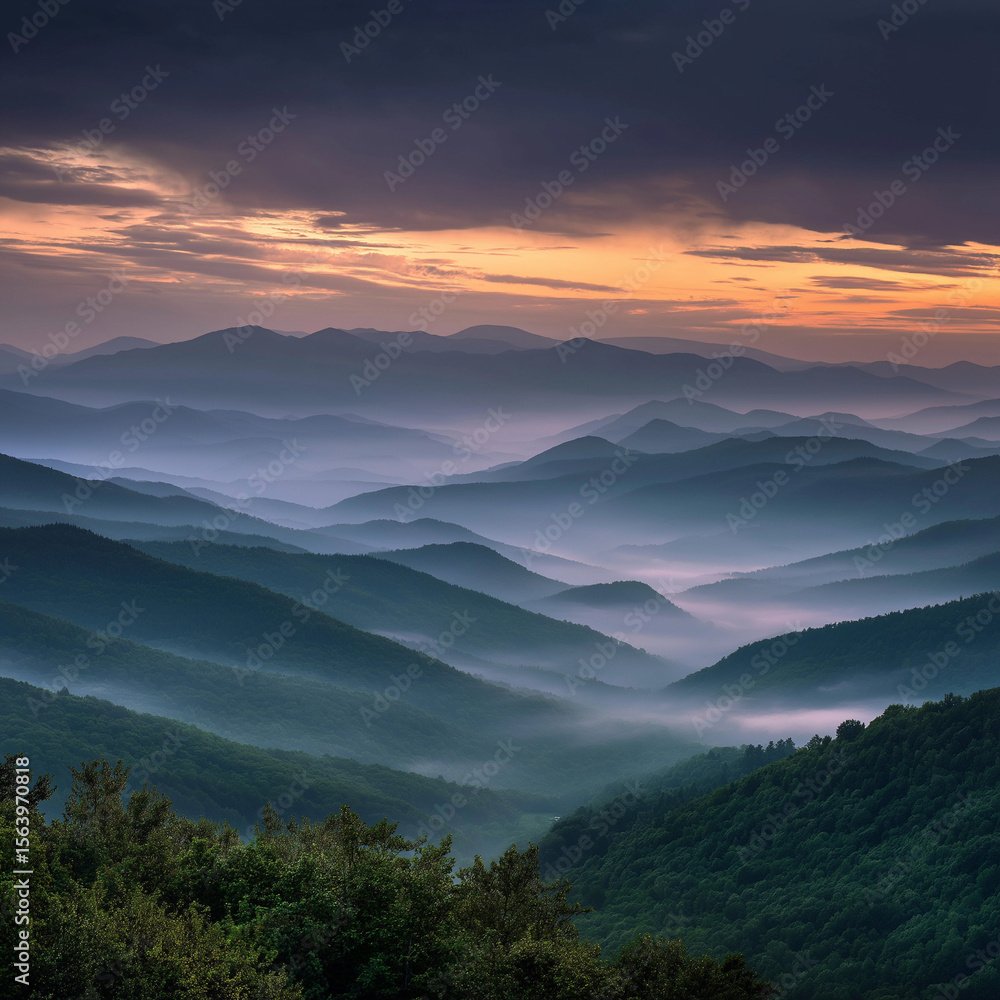 Obraz premium Fog drifting between green mountain layers during early morning sunrise