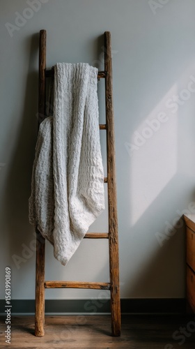 Cozy Blanket Draped on Rustic Wooden Ladder in Warm and Inviting Interior Space for Home Decor Inspiration