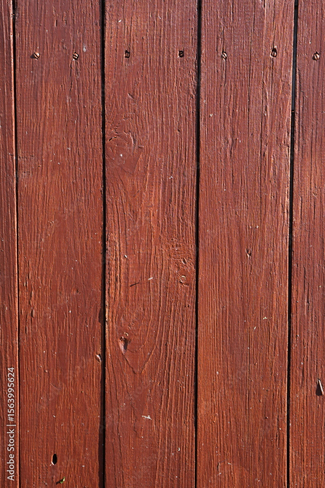 Naklejka premium Rustic Dark Red Wooden Planks with Visible Grain and Nails