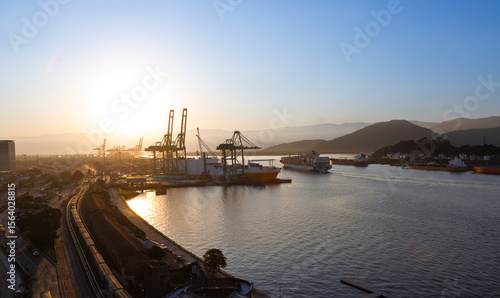 Movement in the port of Santos during sunset, with ships entering