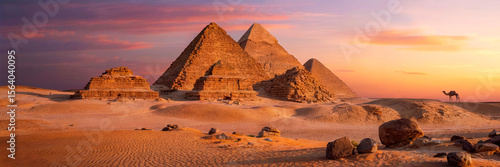 Timeless Sandstone Pyramids in Sunset Light with Vibrant Sky and Scattered Desert Rocks