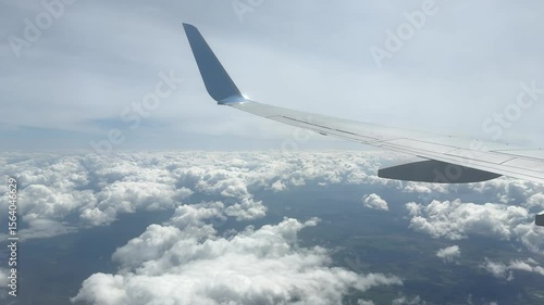Clouds and airplane wing. View from airplane window