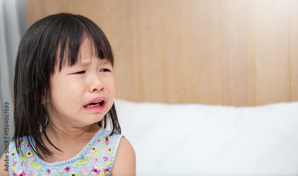 Portrait of little asian crying girl little rolling tears drop cheek weeping emotion hurt pain. Young asian toddler girl in terrible two. Back to school education concept Portrait of little asian crying girl little rolling tears drop cheek weeping emotion hurt pain. Young asian toddler girl in terrible two. Back to school education concept