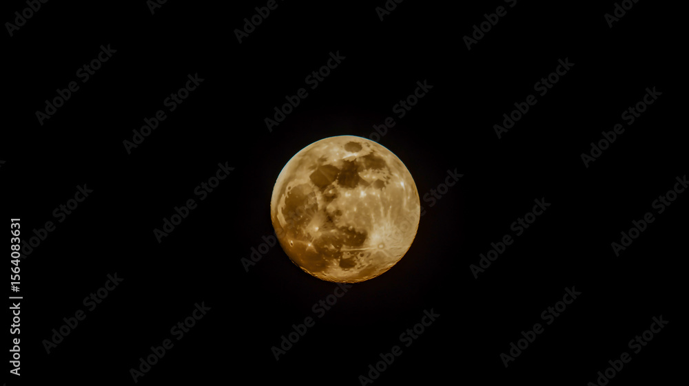 Fototapeta premium A close-up photograph of a half-moon against a pure black background.