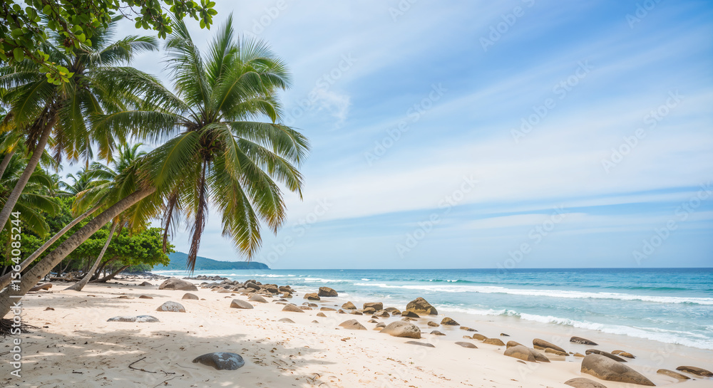 Fototapeta premium Tropical beach with palm trees, rocks, and clear blue sky on sunny day