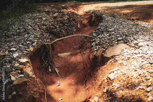 Φωτογραφία close-up of a channel formed on a hillside road caused by fast falling rain