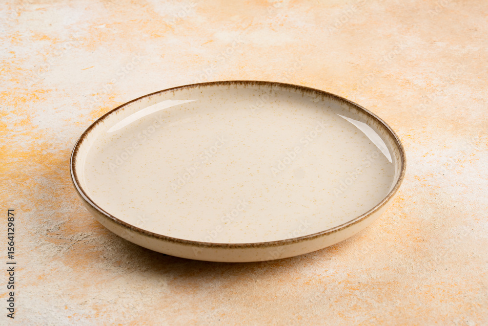 Empty Ceramic Plate on Rustic Stone Table. Minimalist Dining Concept Empty Ceramic Plate on Rustic Stone Table. Minimalist Dining Concept