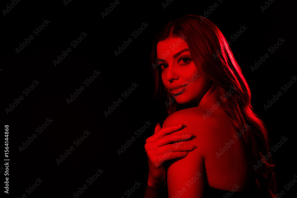 Obraz premium Photo of chic lady clubber feel tempting flirty touch hand shoulders over dark red neon color background
