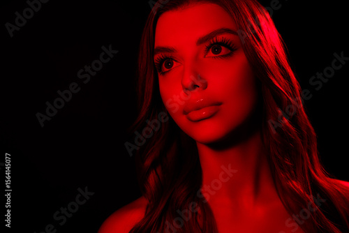 Portrait of attractive tender young lady looking empty space model isolated multicolor disco red neon black background