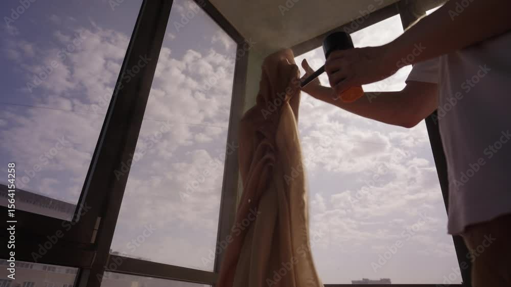 Man removing dust from curtains using portable vacuum cleaner to eliminate dust particles, creating clean and healthy environment in residential or commercial space under bright cloudy sky, close-up Man removing dust from curtains using portable vacuum cleaner to eliminate dust particles, creating clean and healthy environment in residential or commercial space under bright cloudy sky, close-up