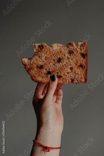 Hand Holding Slice of Panettone Bread