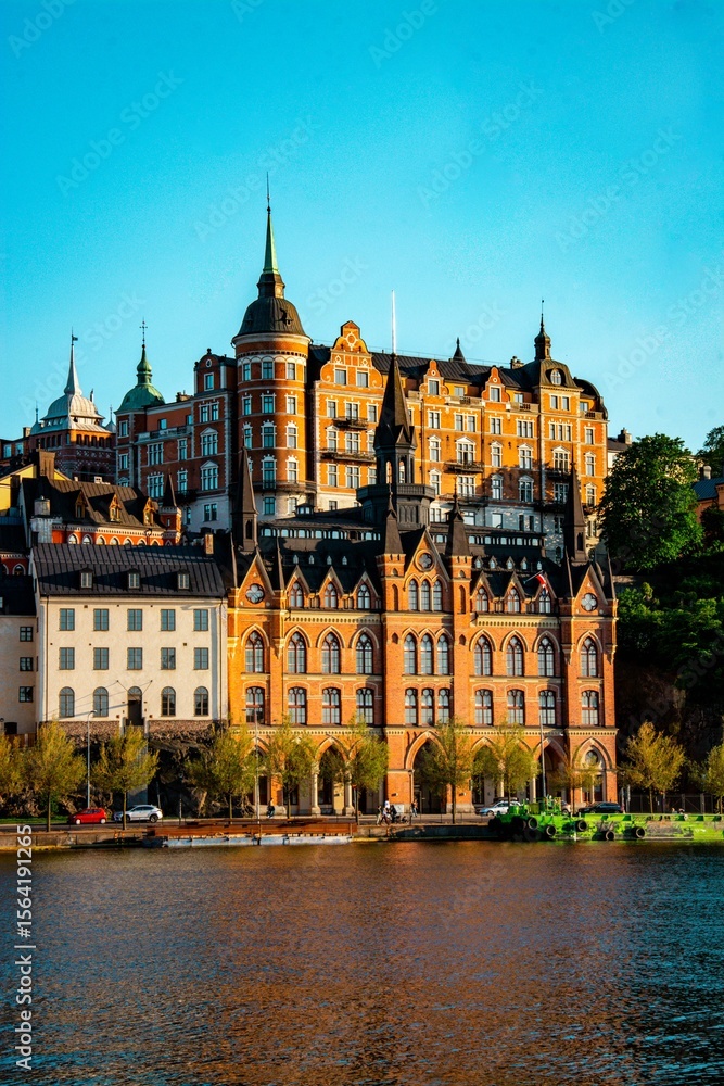 Fototapeta premium Historic Munchenbryggeriet along Stockholm's waterfront under a blue sky