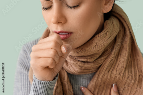 Ill young woman coughing on...