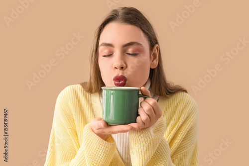 Young woman with cup of hot...
