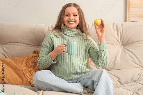 Young woman with cup of tea...