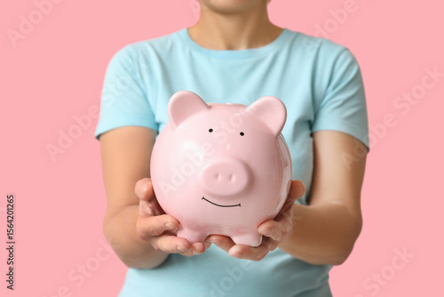 Mature woman with piggy ban...