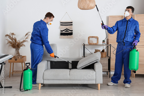 Male workers disinfecting s...