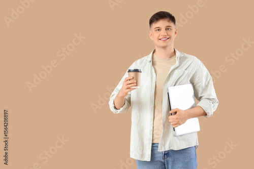 Young man with laptop and c...