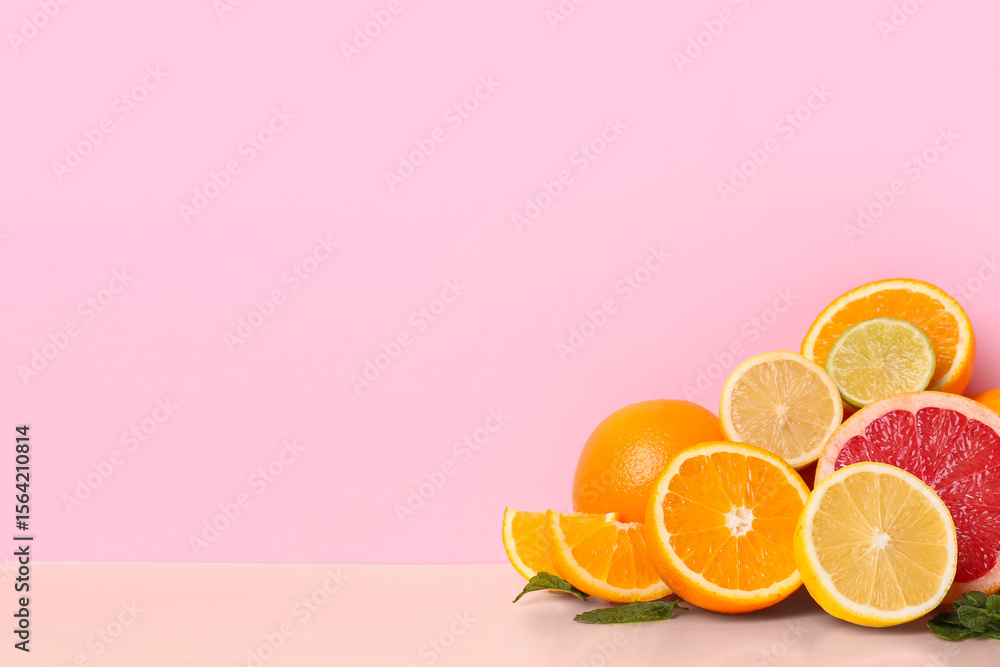Fototapeta premium Different cut citrus fruits and mint leaves on color background