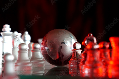 Crystal planet Earth amidst chess pieces showing the American continent, representing concepts of geopolitics, global power, competition for control, international relations, world leaders, struggle f