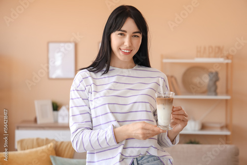 Young woman with glass of i...