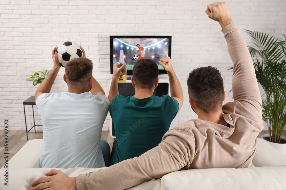 © New Africa - Football fans watching soccer match on TV set at home, back view © New Africa - Football fans watching soccer match on TV set at home, back view